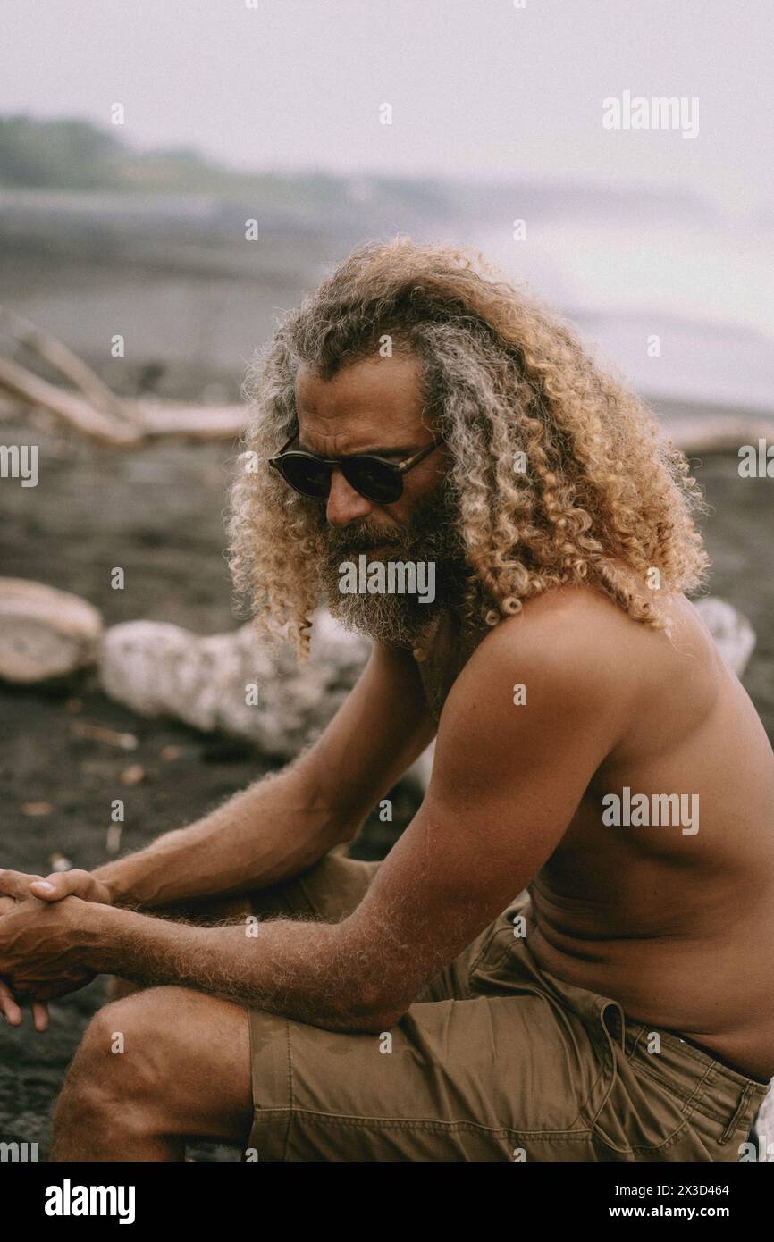 Stylish man with long curly blond hair Stock Photo