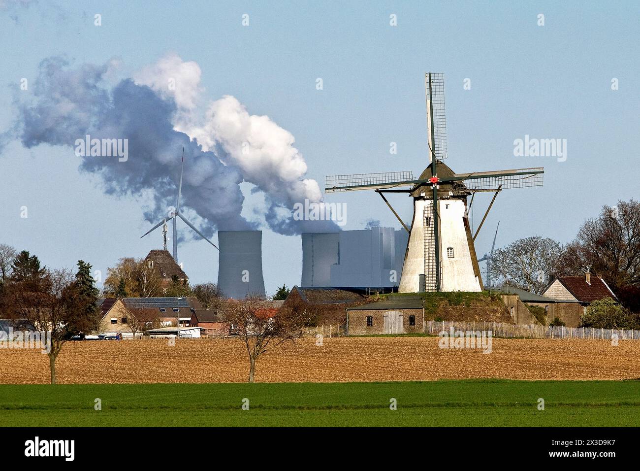 Historic Grottenherten windmill in front of the Neurath lignite-fired power station, Germany, North Rhine-Westphalia, Bedburg Stock Photo