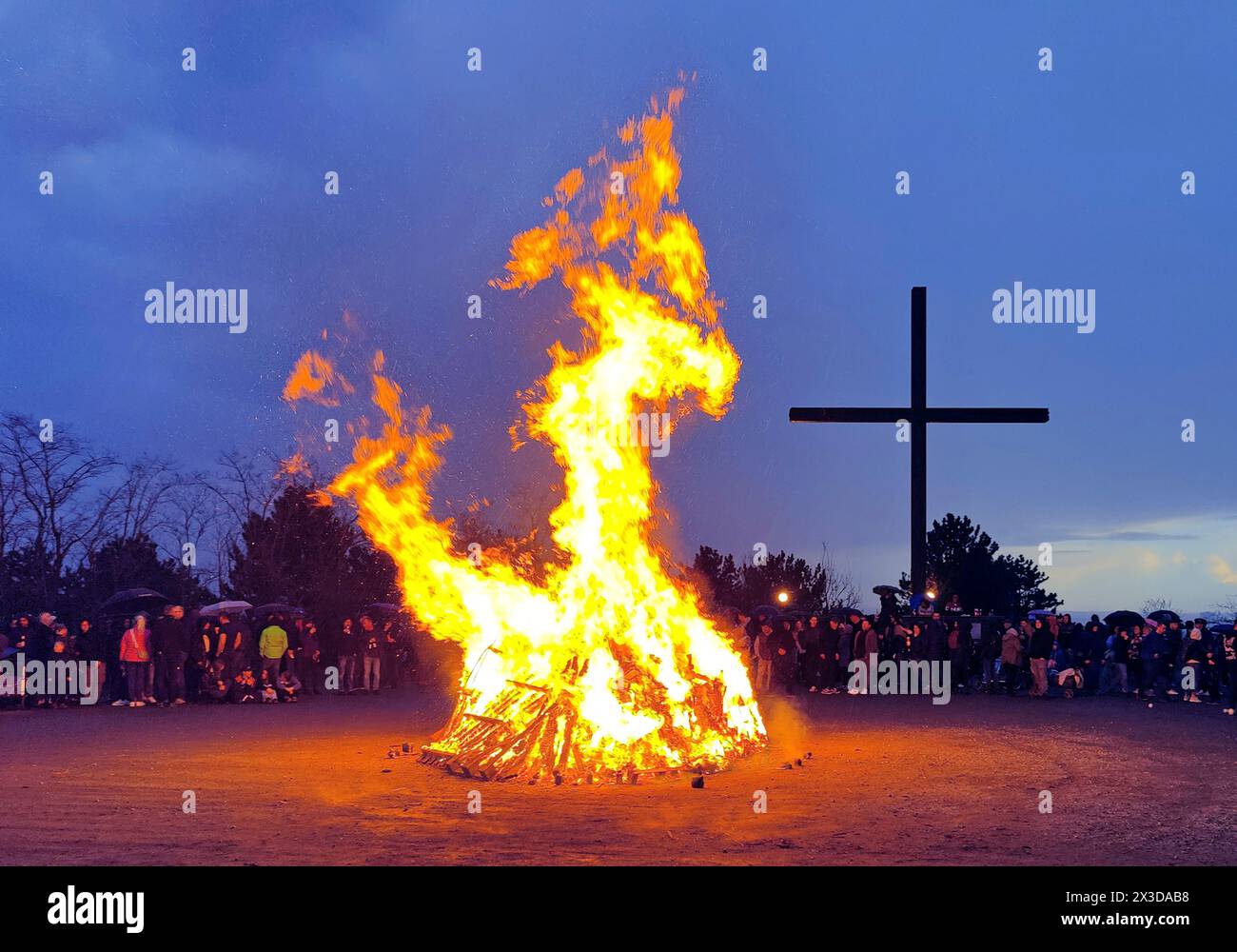 Easter bonfire on the Haniel spoil tip in front of the summit cross, Germany, North Rhine-Westphalia, Ruhr Area, Bottrop Stock Photo