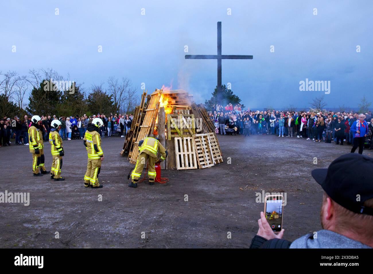 fire brigade lights the Easter fire on the Haniel spoil tip in front of the summit cross, Germany, North Rhine-Westphalia, Ruhr Area, Bottrop Stock Photo