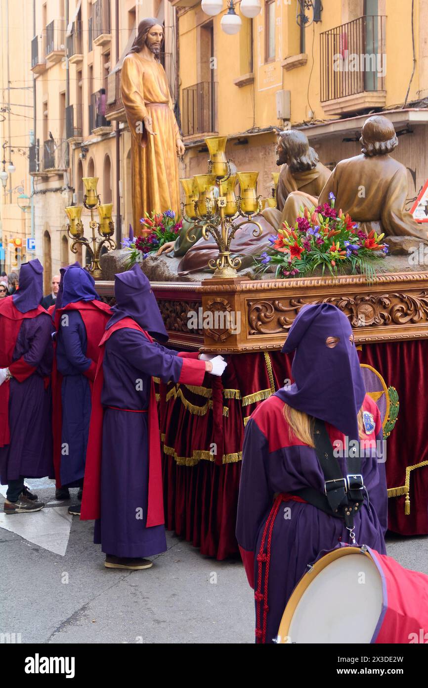 Tarragona, Spain - April 26, 2024: Holy Week procession in Tarragona, showing adorned religious figures and participants in traditional tunics, evokin Stock Photo