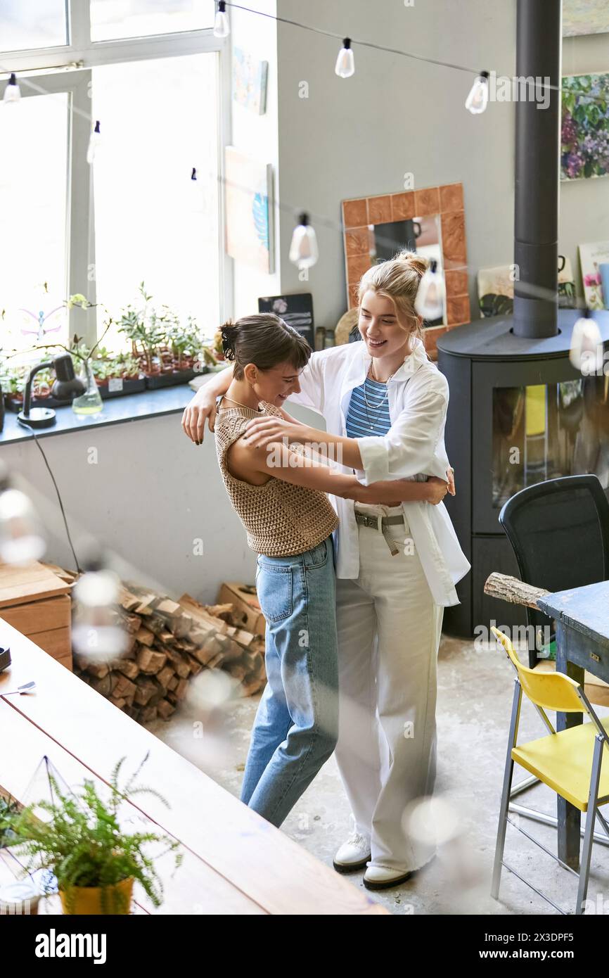 Lesbian couple standing together in art studio. Stock Photo