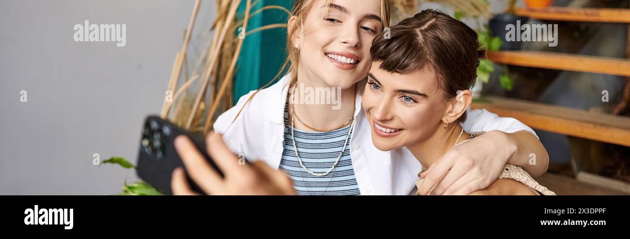 A woman and her girlfriend pose for a selfie in an art studio. Stock Photo