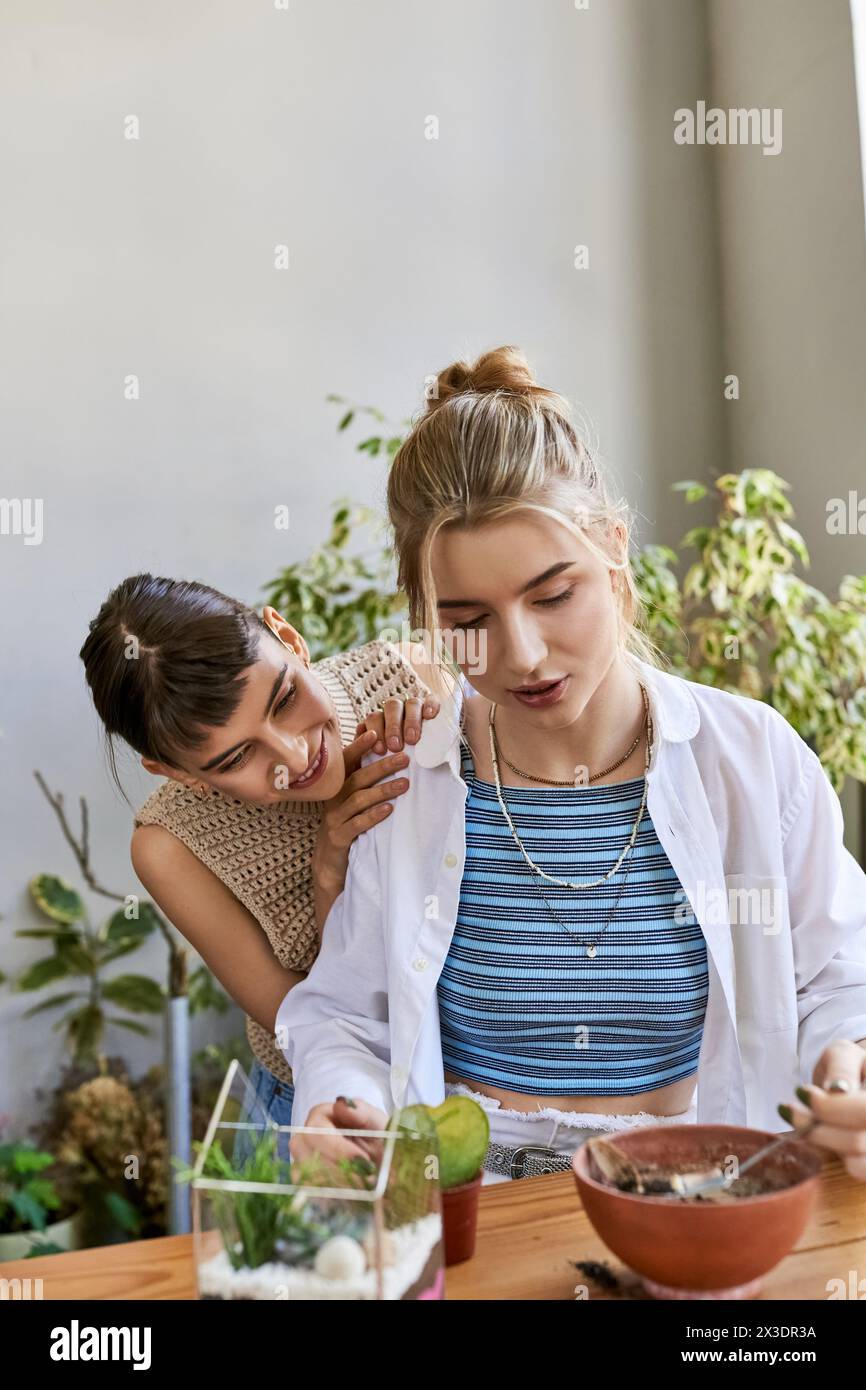 Two women at a table, enjoying each other in an art studio. Stock Photo
