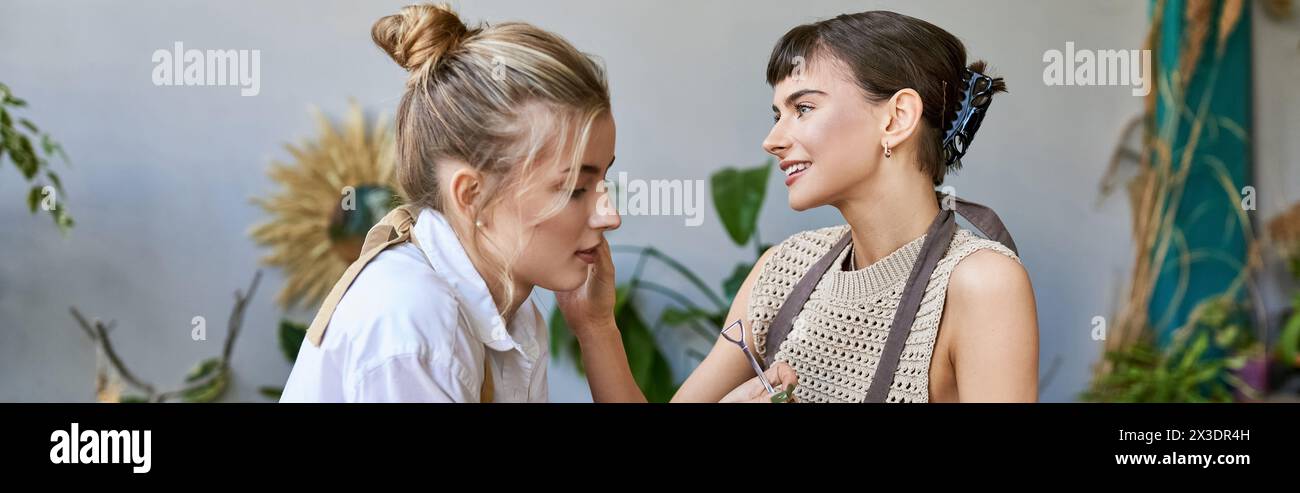 Two women engage in a heartfelt conversation in an art studio. Stock Photo