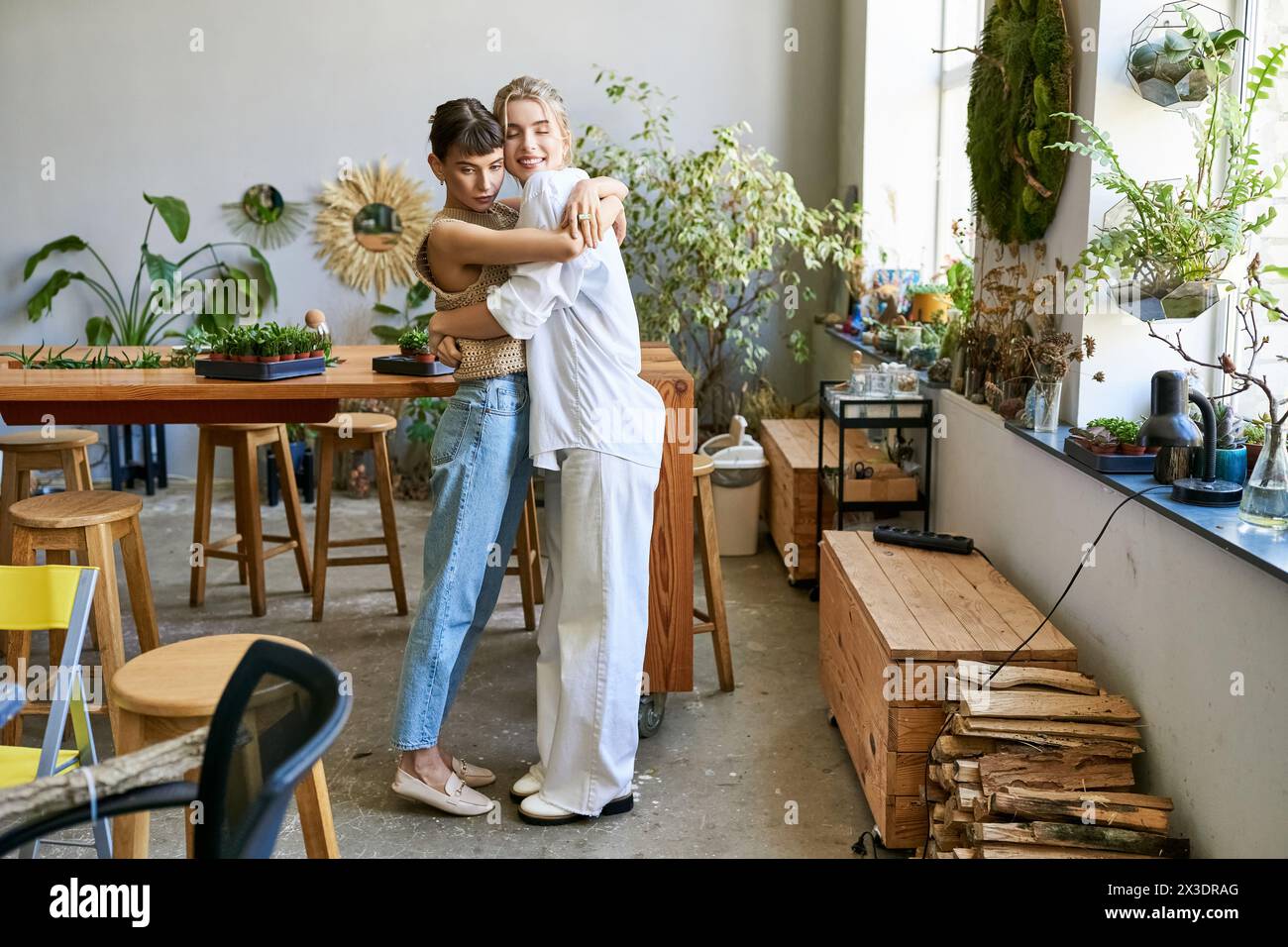 A loving lesbian couple, two women, at an art studio Stock Photo