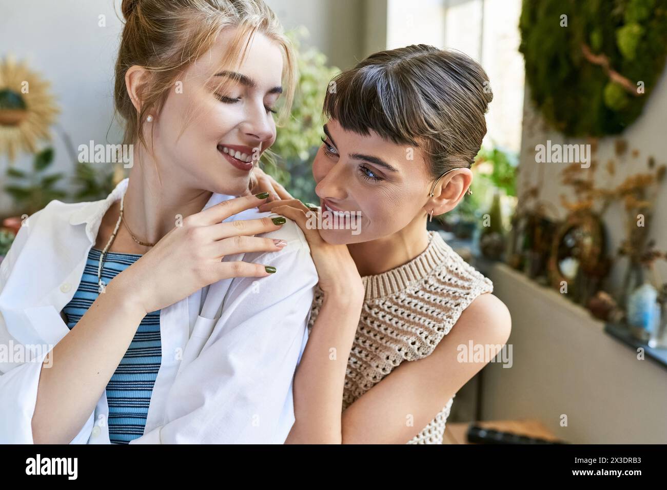 A woman lovingly hugs her girlfriend in an intimate moment. Stock Photo
