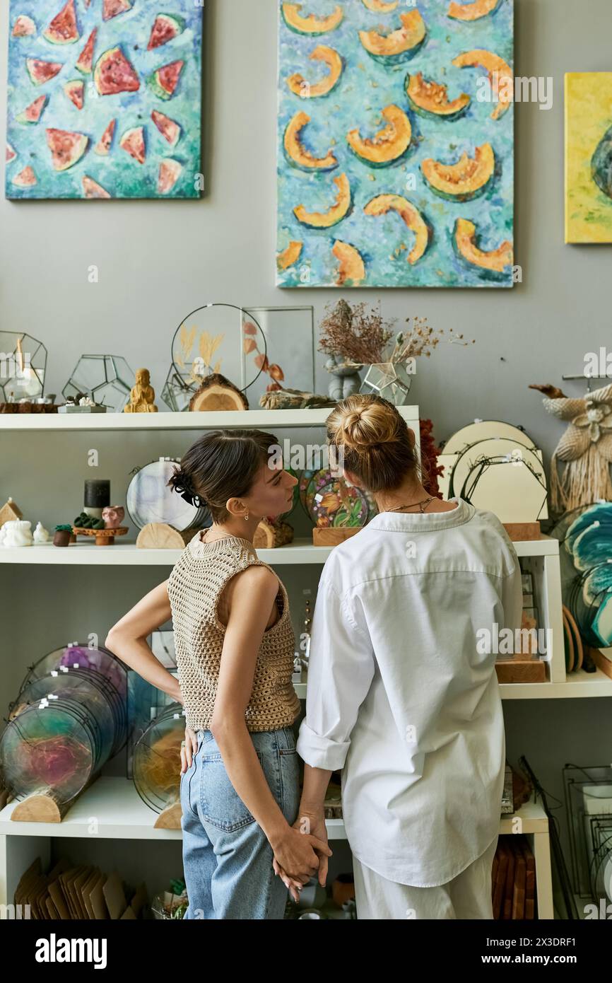 Two women in an art studio, sharing a tender moment. Stock Photo