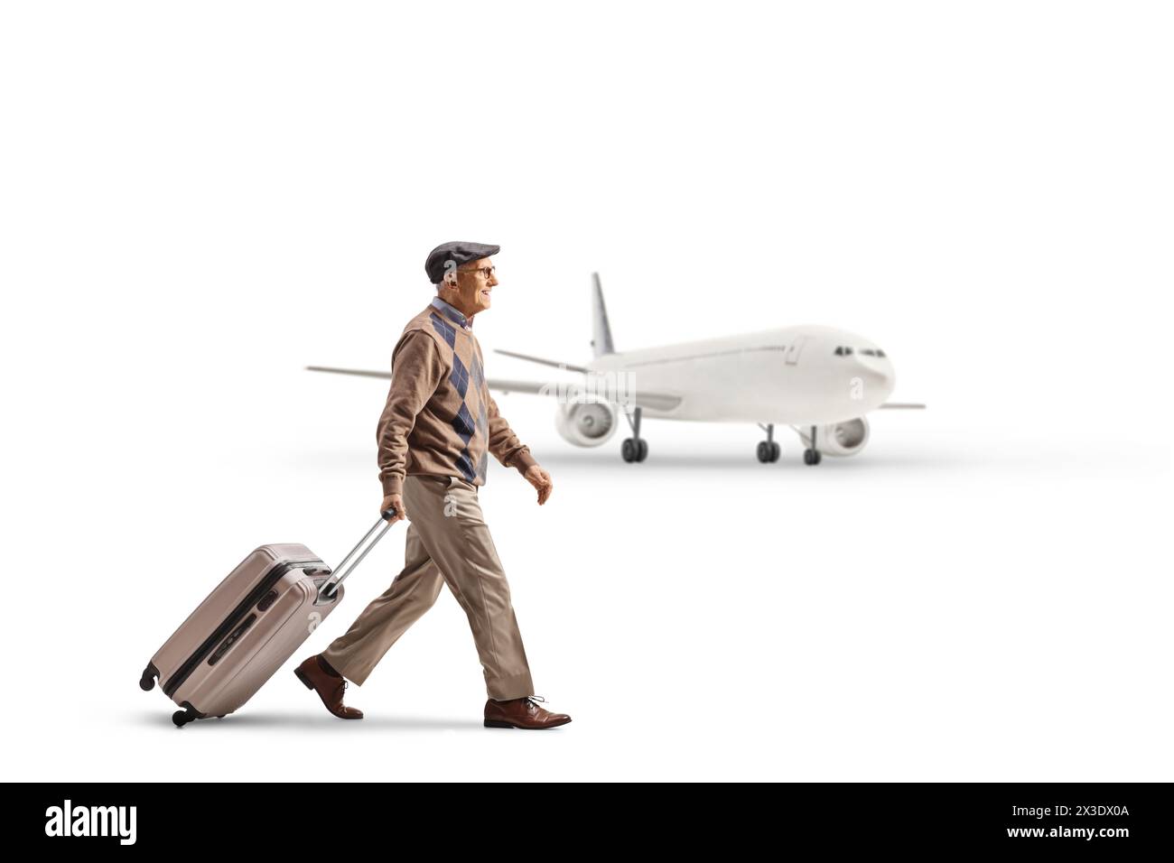 Full length profile shot of an elderly man pulling a suitcase and walking towards an airplane isolated on white background Stock Photo