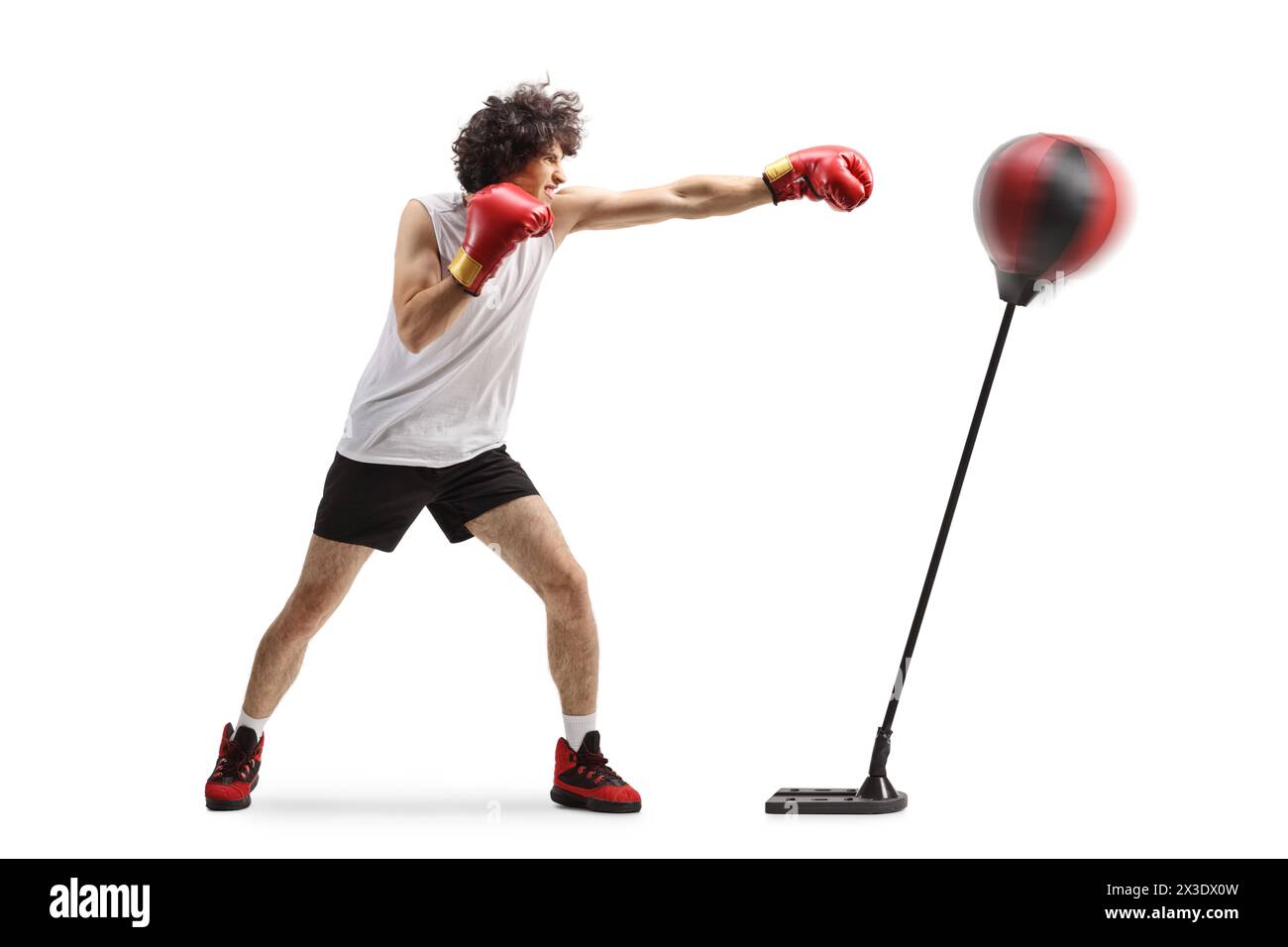 Young man punching a stand with boxing gloves isolated on white background Stock Photo