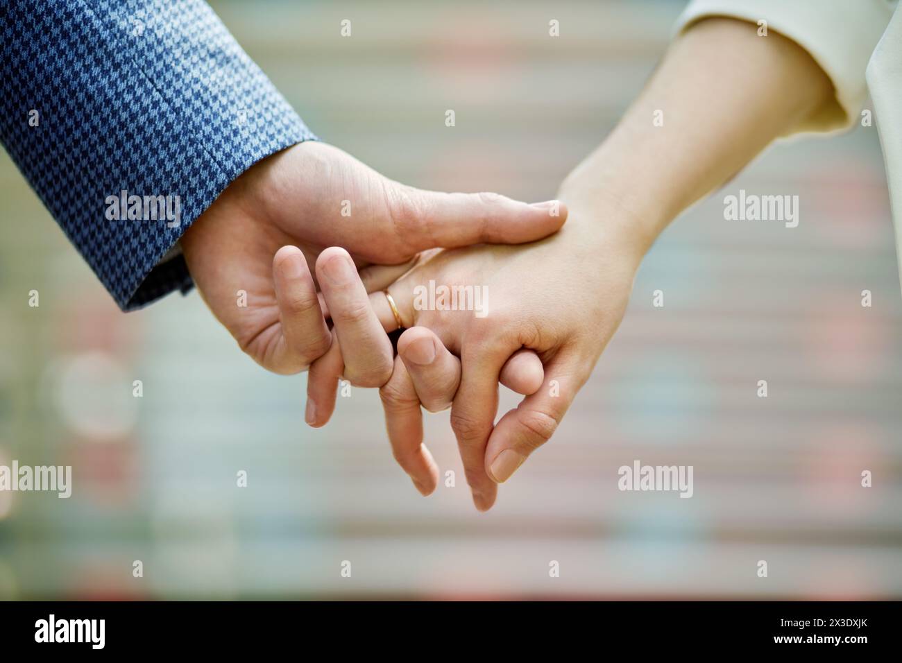 Couple hands held together, closeup. Stock Photo