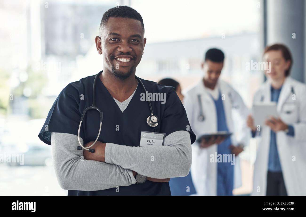 Black man, nurse and arms crossed in hospital or medical meeting with confidence, integrity or about us. Portrait of healthcare doctor in leadership Stock Photo