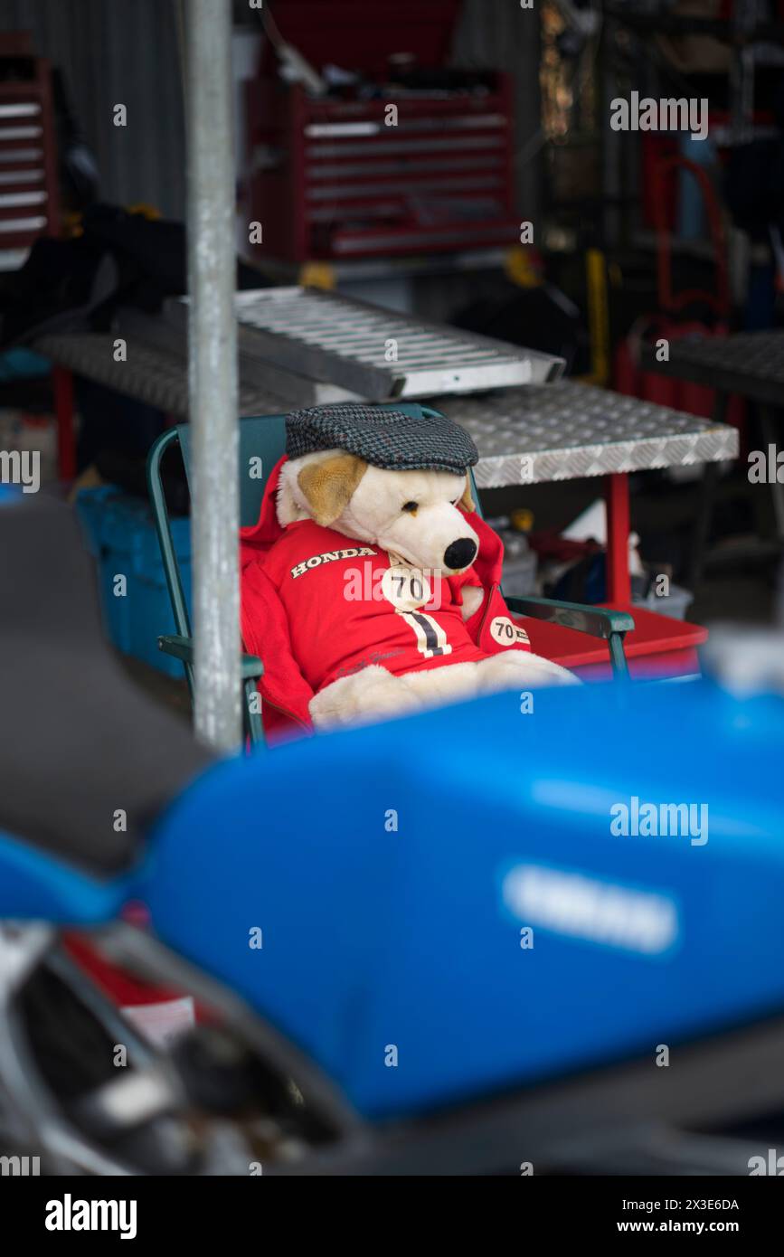 Toy dog mascot dressed in team colours of 1970 Smith Honda CR-S of Andy Smith, 81st Members' Meeting, Goodwood Motor Racing Circuit, Chichester, UK Stock Photo