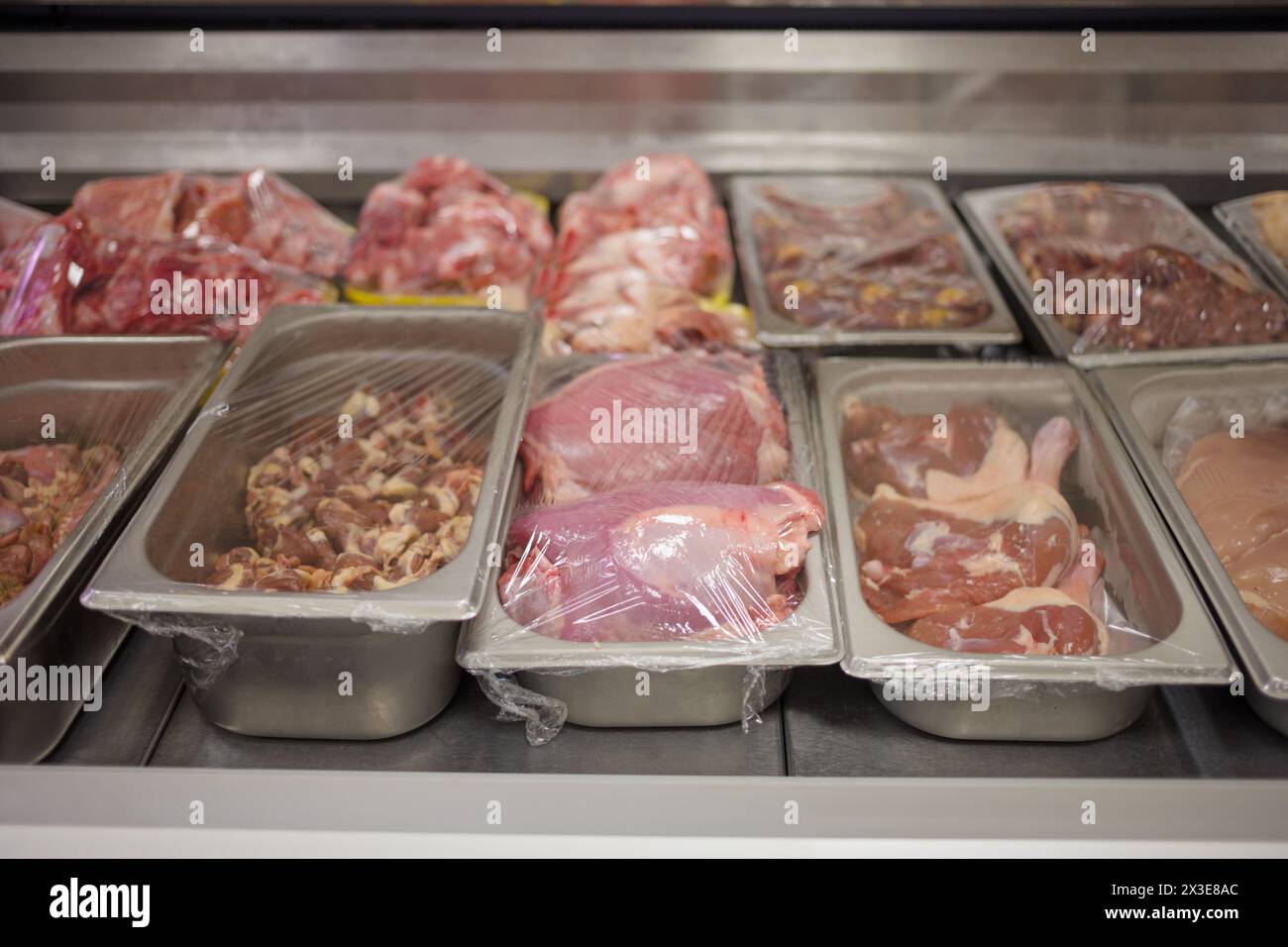 Different grades of meat in shop duck thighs chicken hearts chicken
