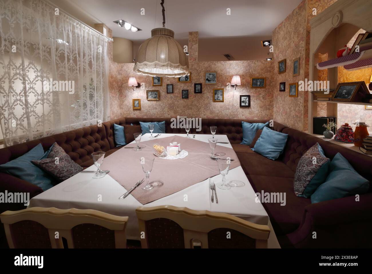 Serving on table with tablecloth in home-style restaurant with couch Stock Photo