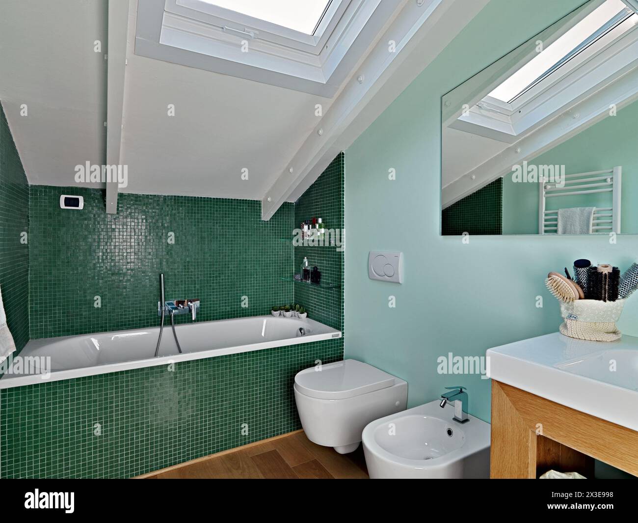 interior view of a modern bathroom in the attic room in the aforegorund there is a bathtub and the sanitary ware Stock Photo