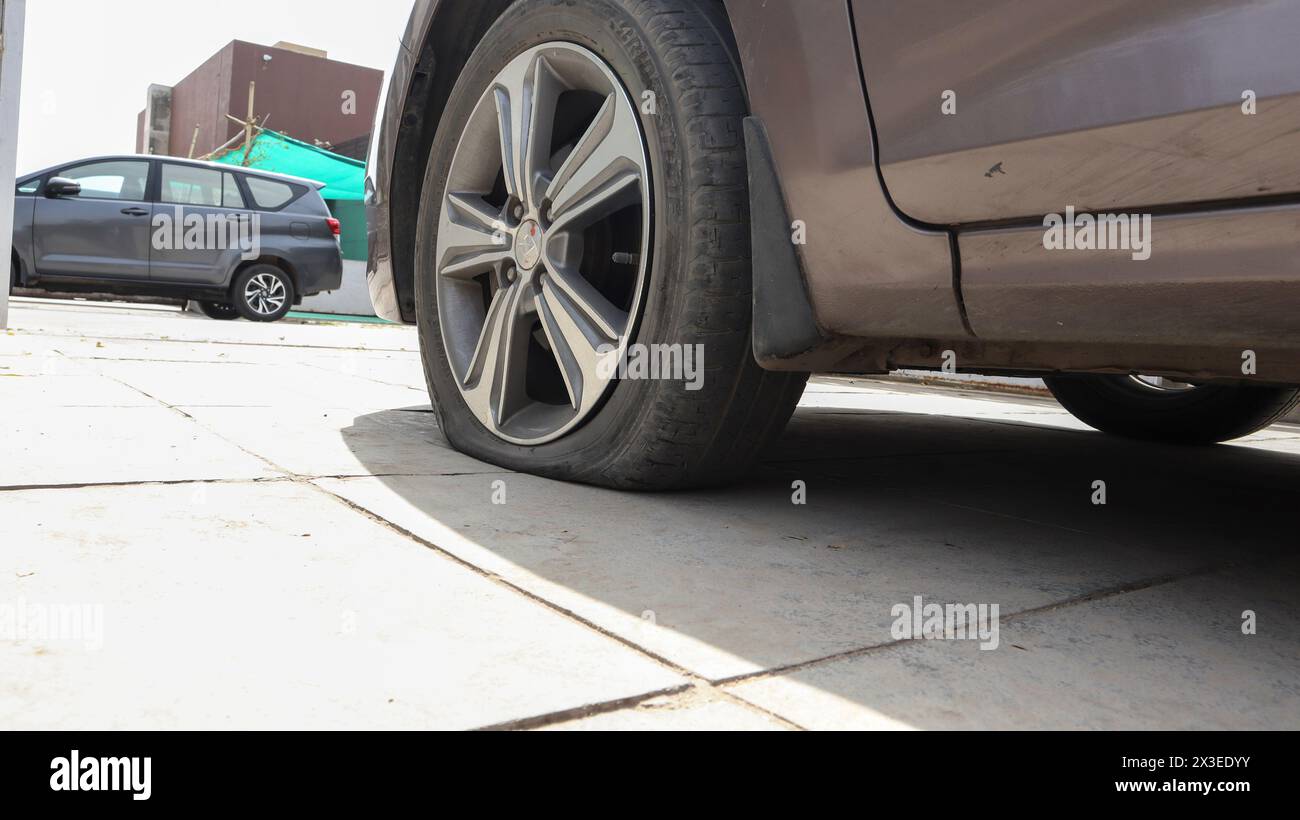 Flat tyre car, Flat car tire wheel punctured in house Stock Photo