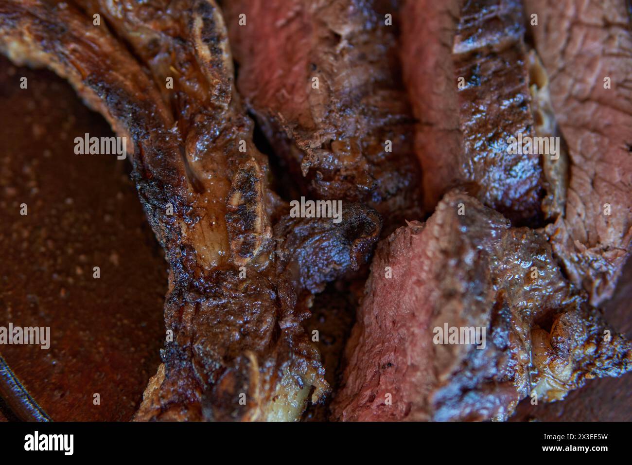 photo of close-up of argentinean asado. roast beef ribs, traditional Argentine food.. Barbecue Stock Photo