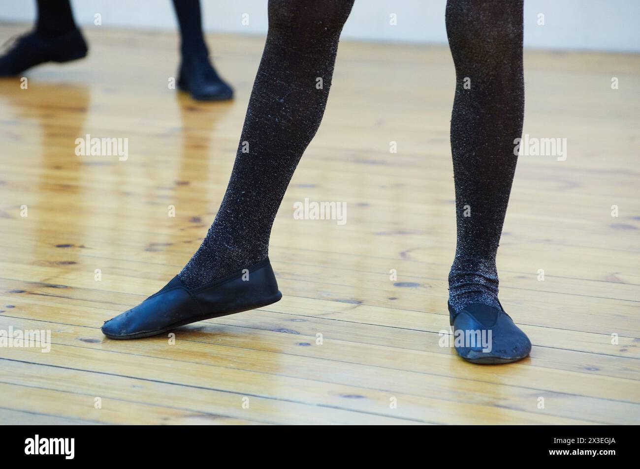 Step into Focus: Legs in Tights on Hardwood Floor Stock Photo