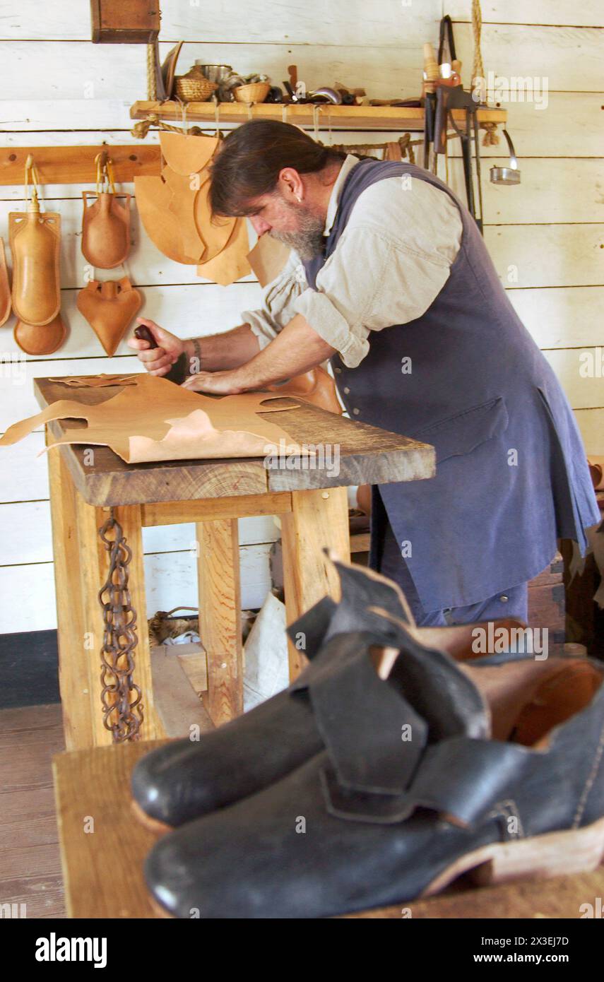 Man in colonial clothes makes shoes St Augustine Florida USA Stock Photo