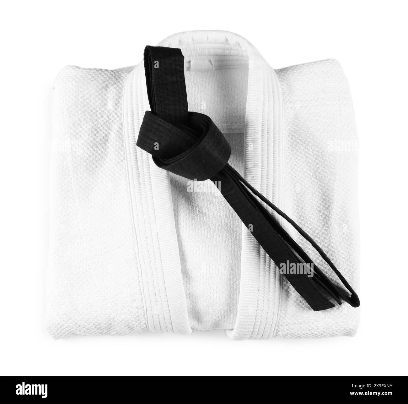 Martial arts uniform with black belt isolated on white, top view Stock