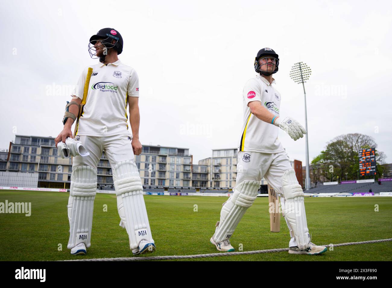 Bristol, UK, 26 April 2024. Gloucestershire's James Bracey (left) and Gloucestershire's Miles Hammond walk off the field after bad light stops play during the Vitality County Championship Division Two match between Gloucestershire and Middlesex. Credit: Robbie Stephenson/Gloucestershire Cricket/Alamy Live News Stock Photo