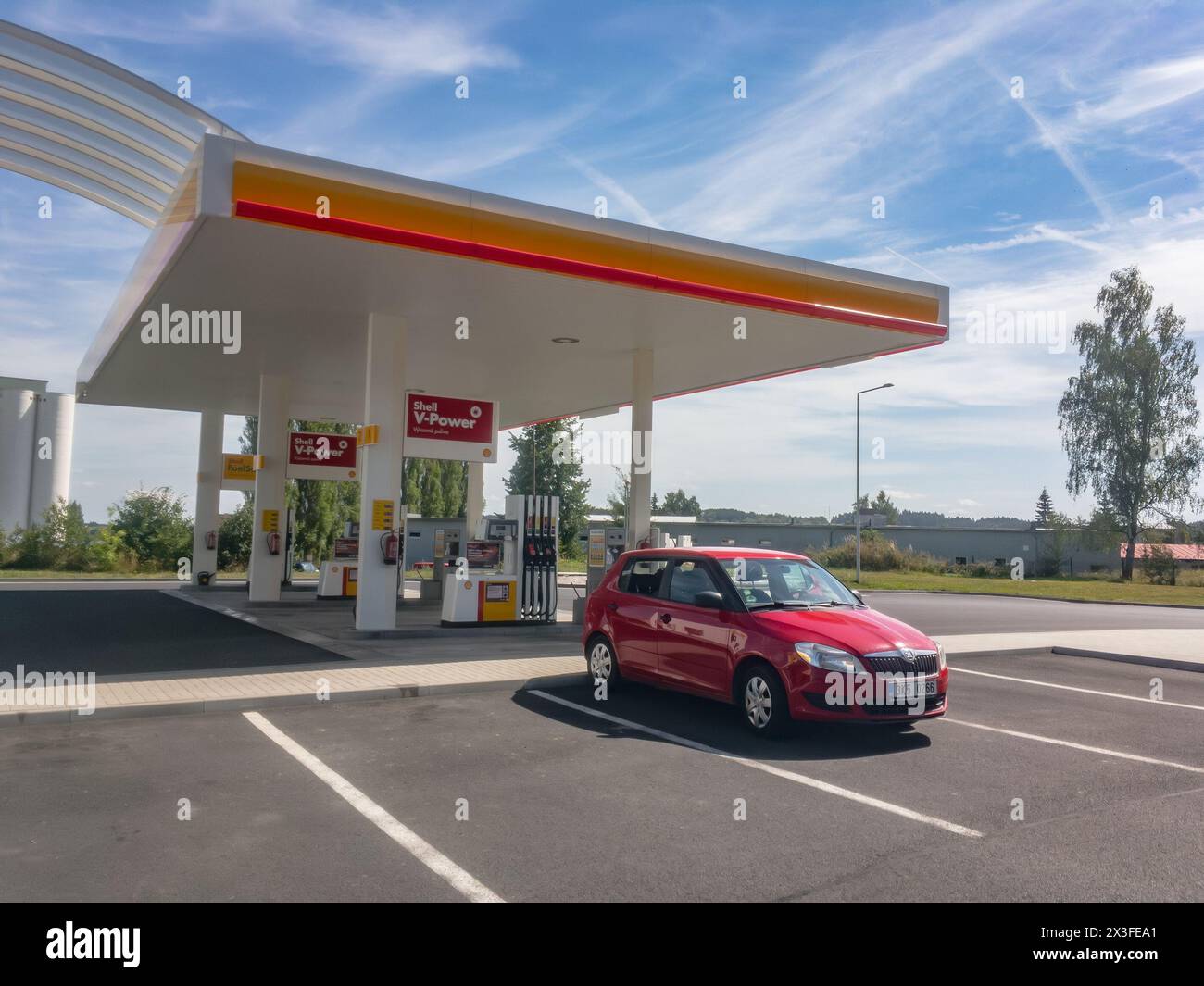 TOUZIM, CZECH REPUBLIC - JULY 31, 2017: Red Skoda Fabia car stopped for fueling and relax at Shell gas station Stock Photo