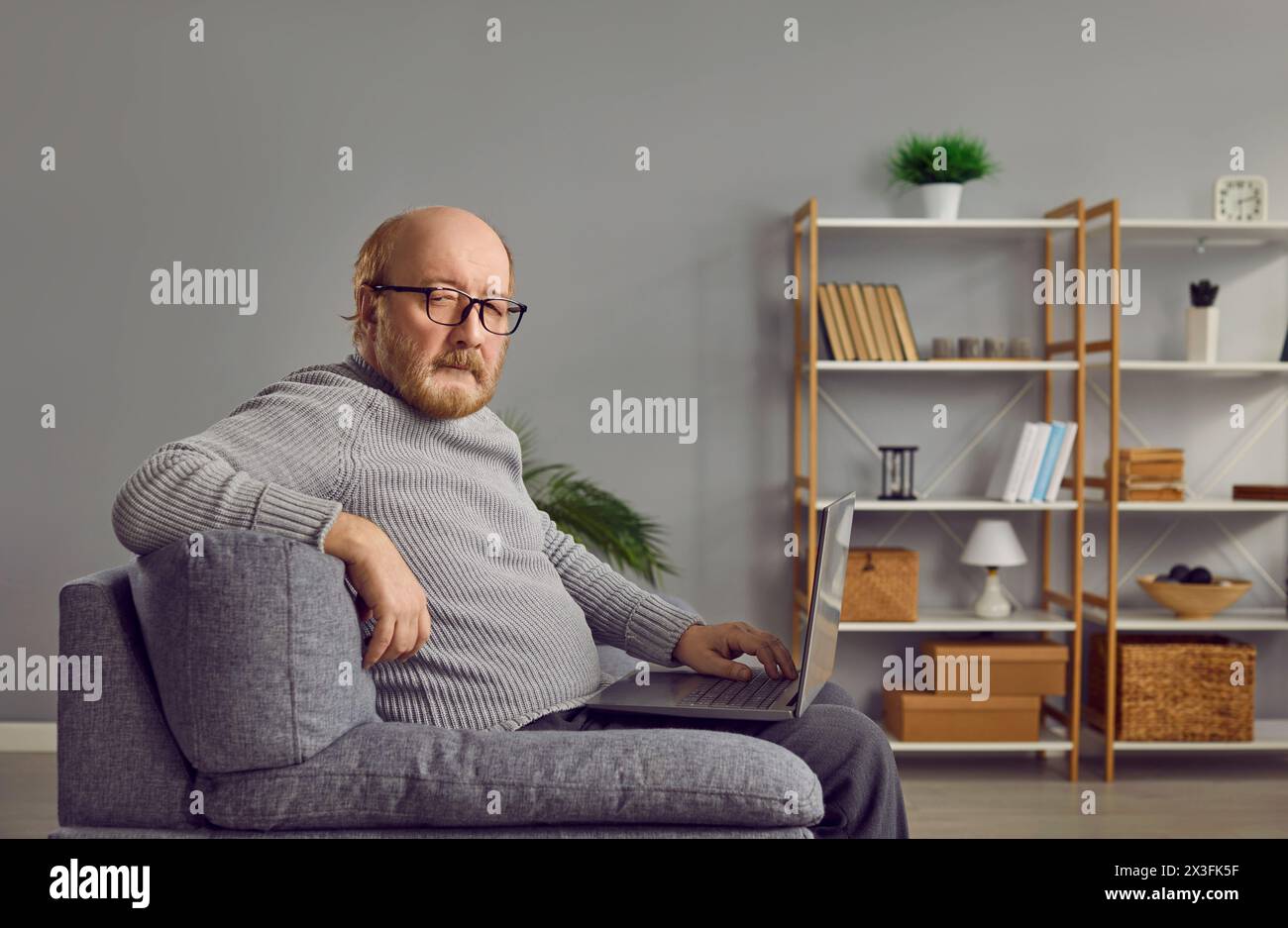 Senior man sitting on couch hi-res stock photography and images - Alamy