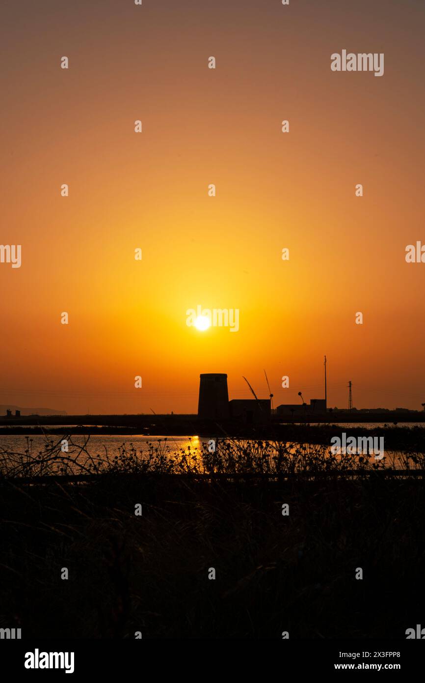 Old windmill in Saline di Trapani e Paceco on sunset, Sicily. Stock Photo