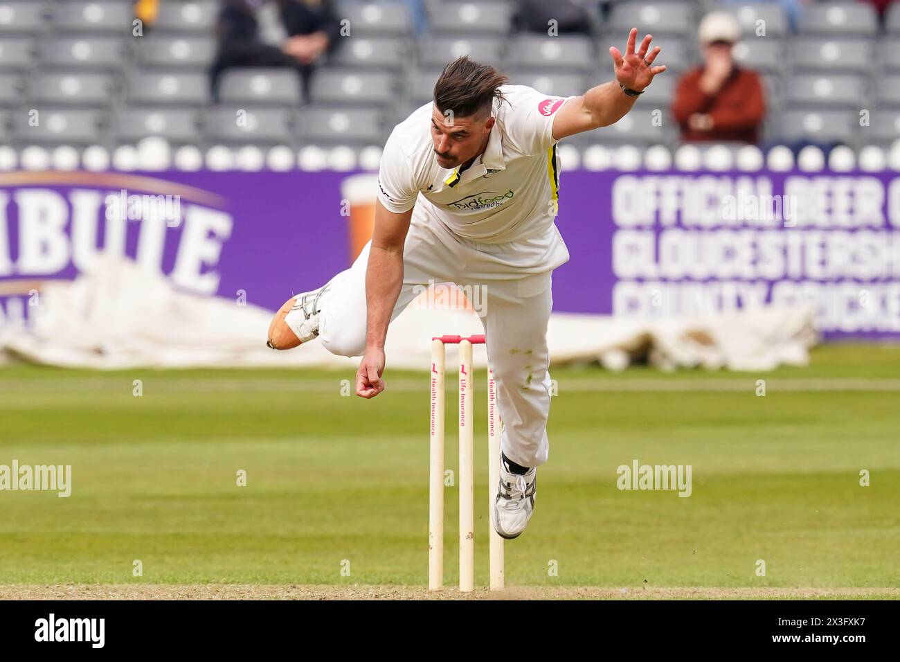 Bristol, UK, 26 April 2024. Gloucestershire's Marchant de Lange bowling during the Vitality County Championship Division Two match between Gloucestershire and Middlesex. Credit: Robbie Stephenson/Gloucestershire Cricket/Alamy Live News Stock Photo