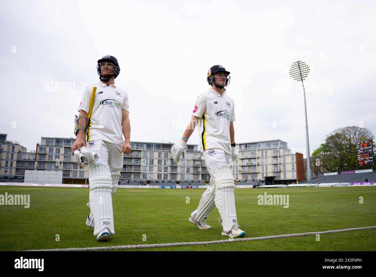 Bristol, UK, 26 April 2024. Gloucestershire's James Bracey and Miles Hammond walk off the field after bad light stops play during the Vitality County Championship Division Two match between Gloucestershire and Middlesex. Credit: Robbie Stephenson/Gloucestershire Cricket/Alamy Live News Stock Photo