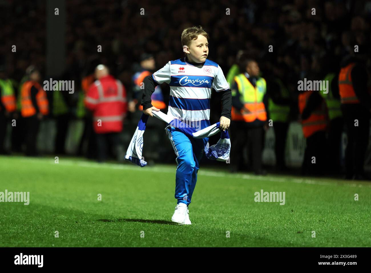 A young Queens Park Rangers fan runs onto the pitch after the final ...