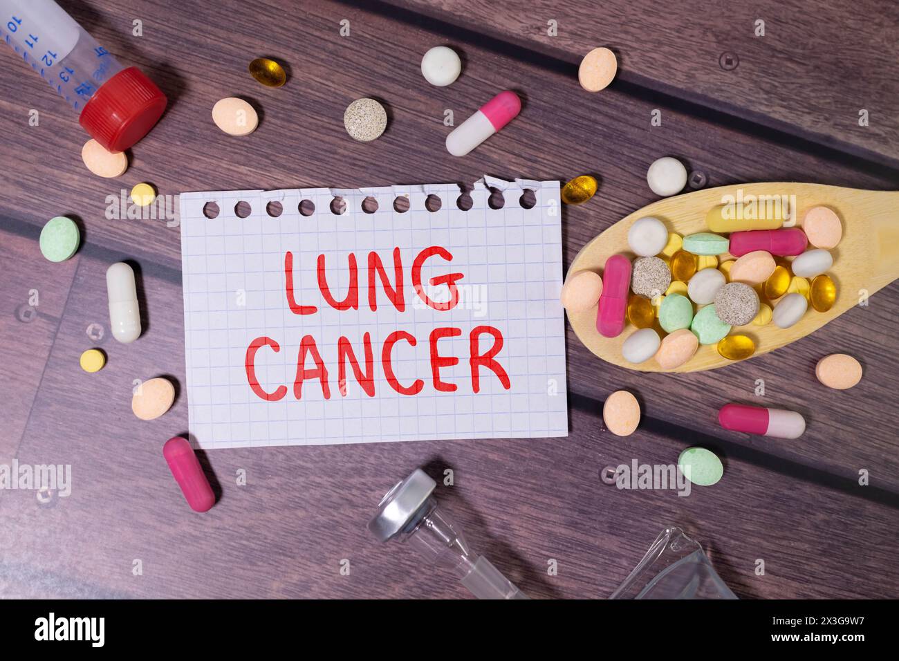 Paper with text LUNG CANCER on blue background with stethoscope and pills Stock Photo