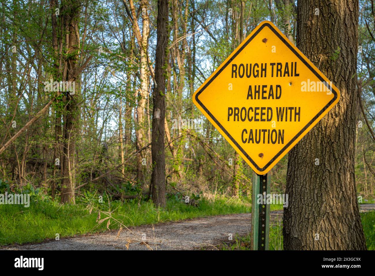 rough trail ahead, proceed with caution - warning sign on Steamboat Trace Trail converted from old railroad near Peru, Nebraska Stock Photo