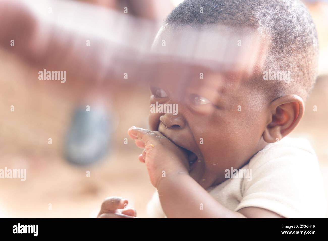 village african baby , violence against children, kid beaten by the family member and crying Stock Photo