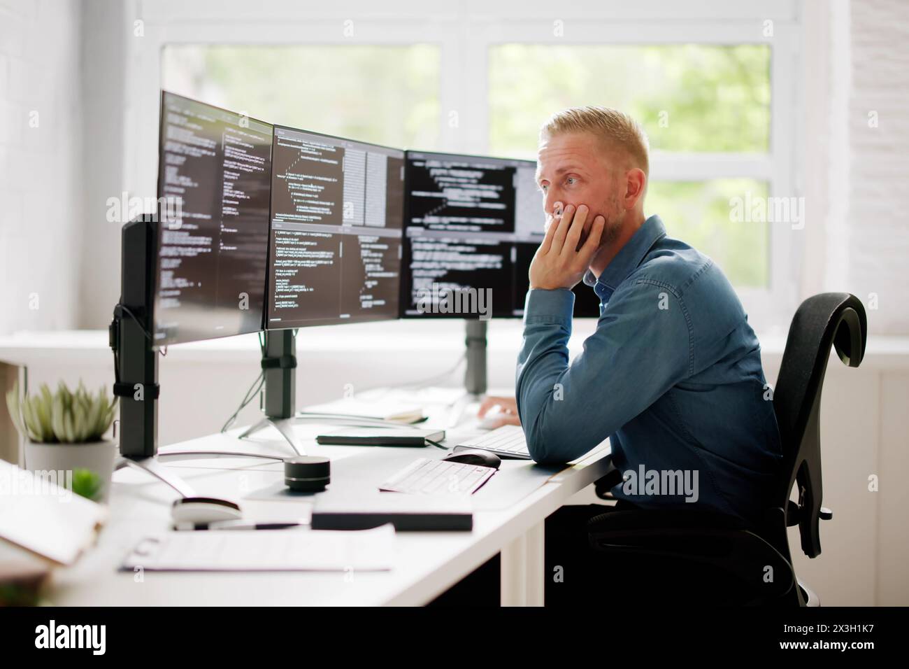Coder Using Computer At Desk. Web Developer Stock Photo