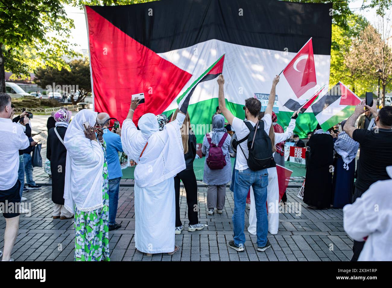 Istanbul, Turkey. 26th Apr, 2024. Protesters hold a huge Palestinian flag during the demonstration. The sit-in protest initiated by the Human Rights and Freedoms (IHH) Humanitarian Relief Foundation at Sultanahmet Square in support of Palestine under Israeli attacks continues on its third day. Credit: SOPA Images Limited/Alamy Live News Stock Photo