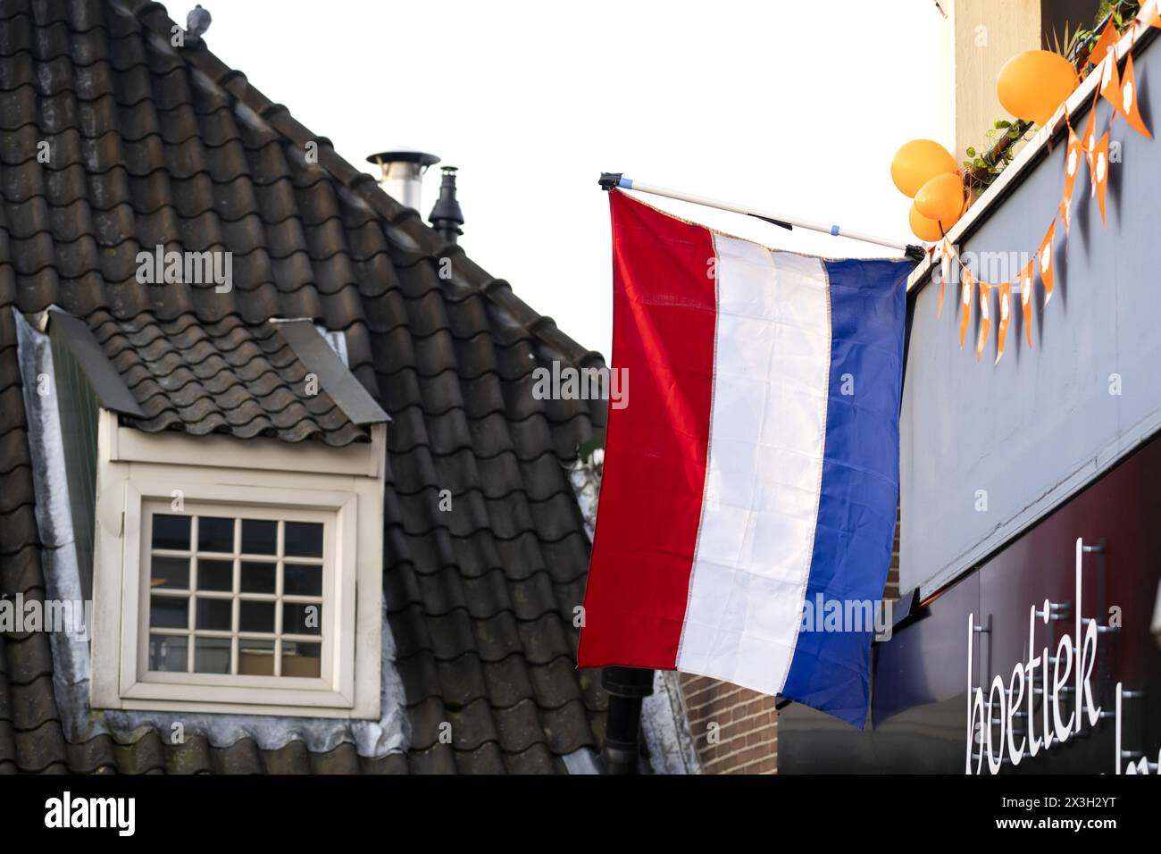 EMMEN - The Dutch flag is flying for King's Day. While the royal family visits Emmen, the national holiday is also being fully celebrated in the rest of the country. ANP SANDER KONING netherlands out - belgium out Stock Photo