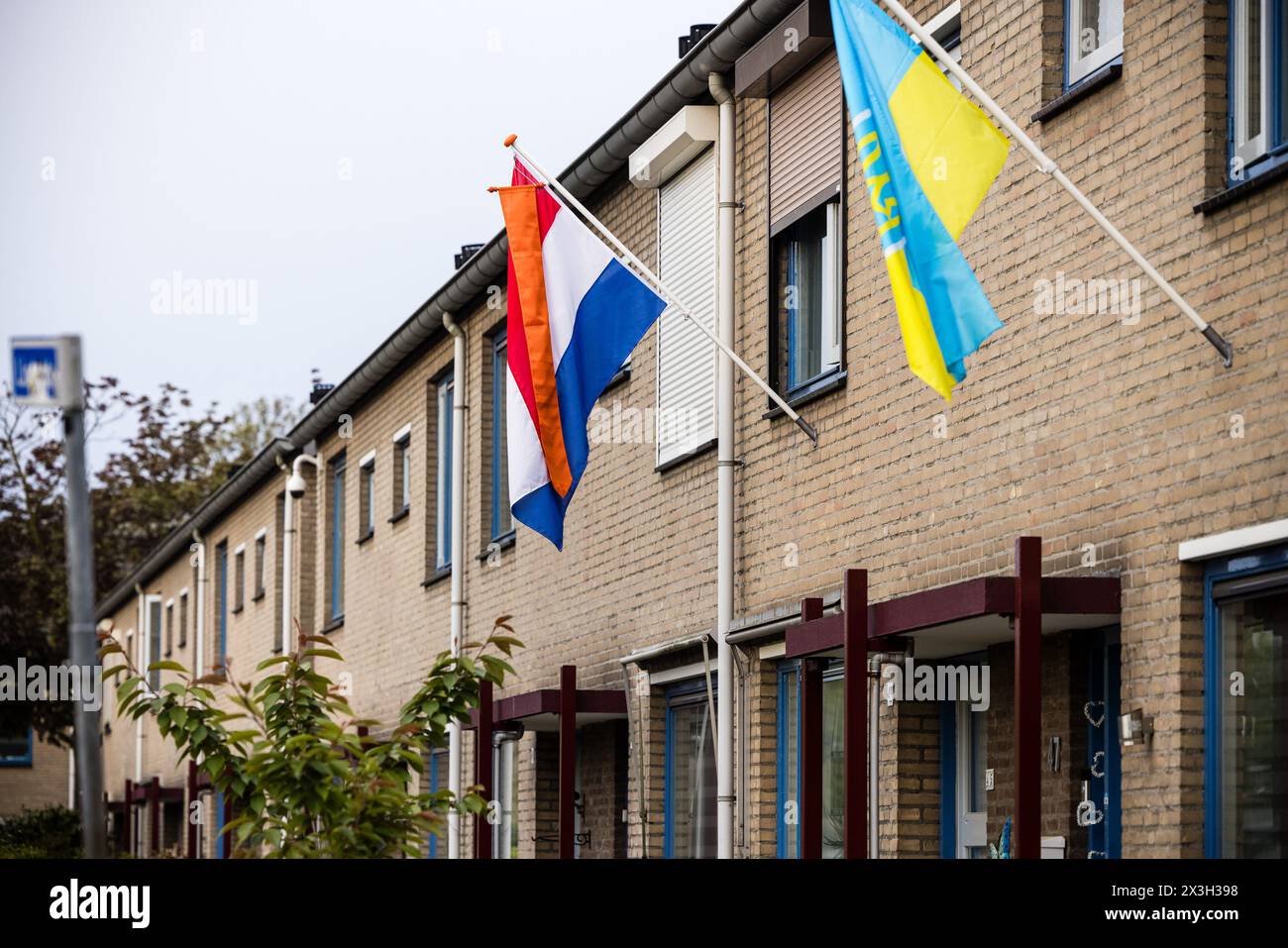 MIERLO - The Dutch flag with an orange pennant hangs next to a Ukrainian flag for King's Day. While the royal family visits Emmen, the national holiday is also being fully celebrated in the rest of the country. ANP ROB ENGELAAR netherlands out - belgium out Stock Photo