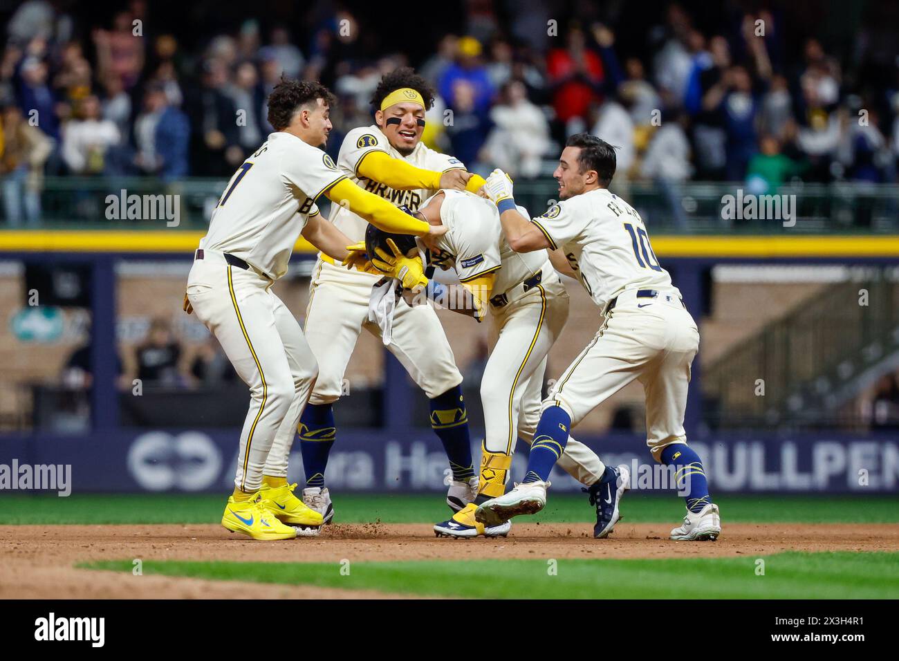 Milwaukee, WI, USA. 26th Apr, 2024. Milwaukee Brewers third base Joey Ortiz (3) is mobbed by teammates outfielder Sal Frelick (10), catcher William Contreras (24), and shortstop Willy Adames (27) after his walk-off hit RBI after the game between the Milwaukee Brewers and the New York Yankees at American Family Field in Milwaukee, WI. Darren Lee/CSM (Credit Image: © Darren Lee/Cal Sport Media). Credit: csm/Alamy Live News Stock Photo