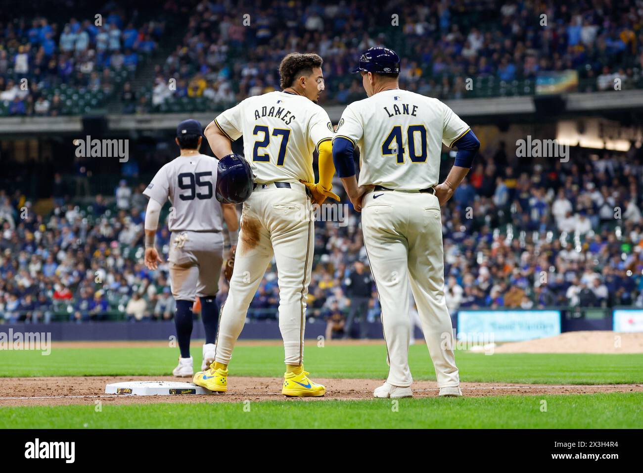Milwaukee, WI, USA. 26th Apr, 2024. Milwaukee Brewers shortstop Willy Adames (27) talks with third base coach Jason Lane (40) during the game between the Milwaukee Brewers and the New York Yankees at American Family Field in Milwaukee, WI. Darren Lee/CSM/Alamy Live News Stock Photo