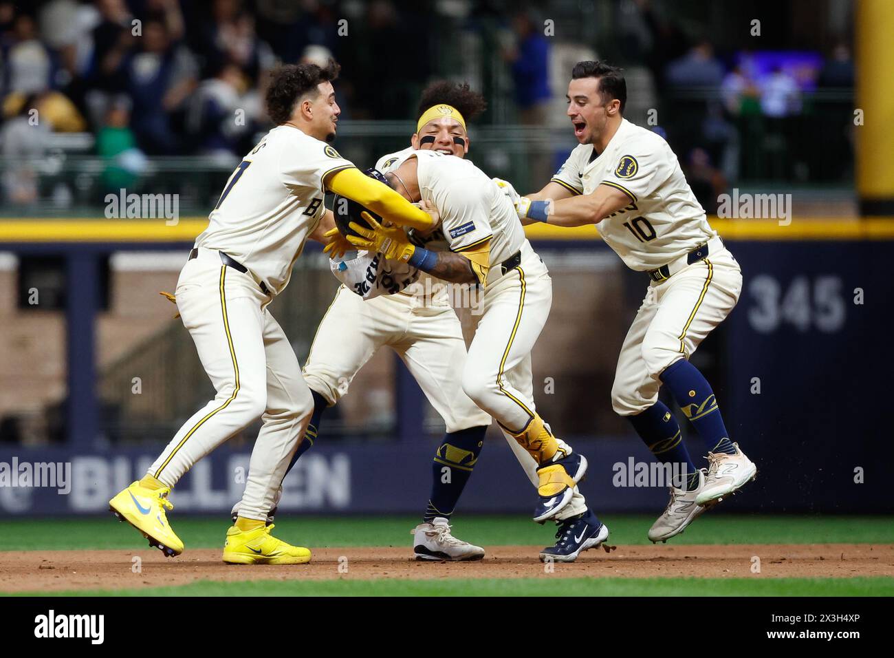 Milwaukee, WI, USA. 26th Apr, 2024. Milwaukee Brewers third base Joey Ortiz (3) is mobbed by teammates outfielder Sal Frelick (10), catcher William Contreras (24), and shortstop Willy Adames (27) after his walk-off hit RBI after the game between the Milwaukee Brewers and the New York Yankees at American Family Field in Milwaukee, WI. Darren Lee/CSM/Alamy Live News Stock Photo