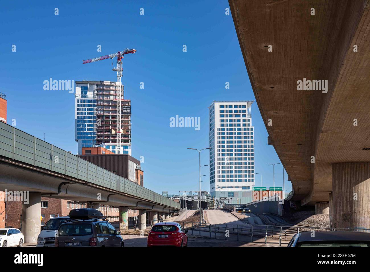 Kalasatama high-rise buildings and Junatie bridge against clear blue sky in Helsinki, Finland Stock Photo