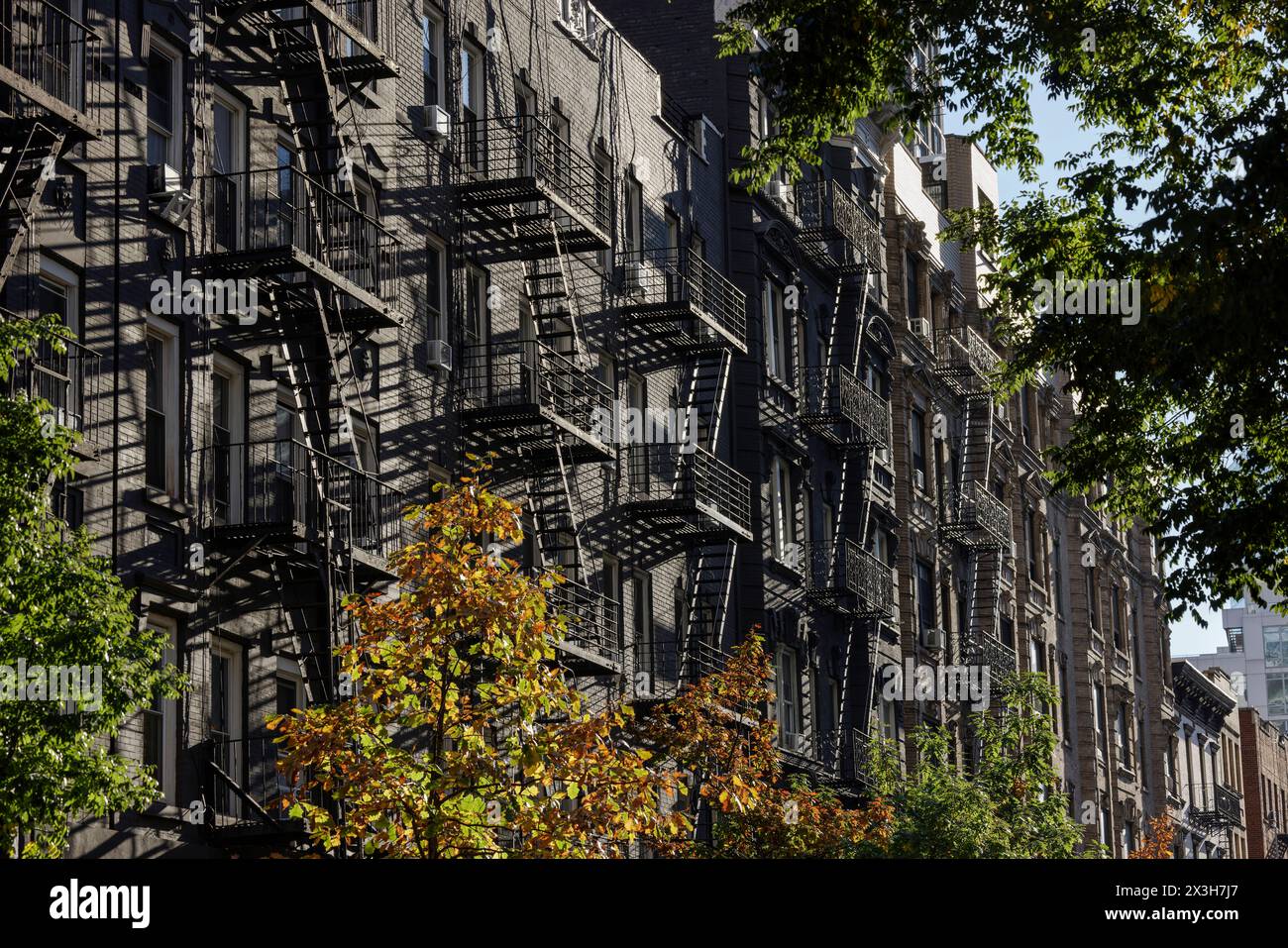 Traditional cast iron fire escapes on apartments on tree lined East