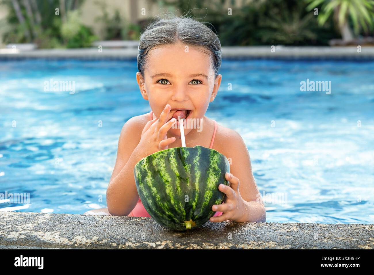 Portrait of a child with watermelon juice in the pool outdoor Stock Photo