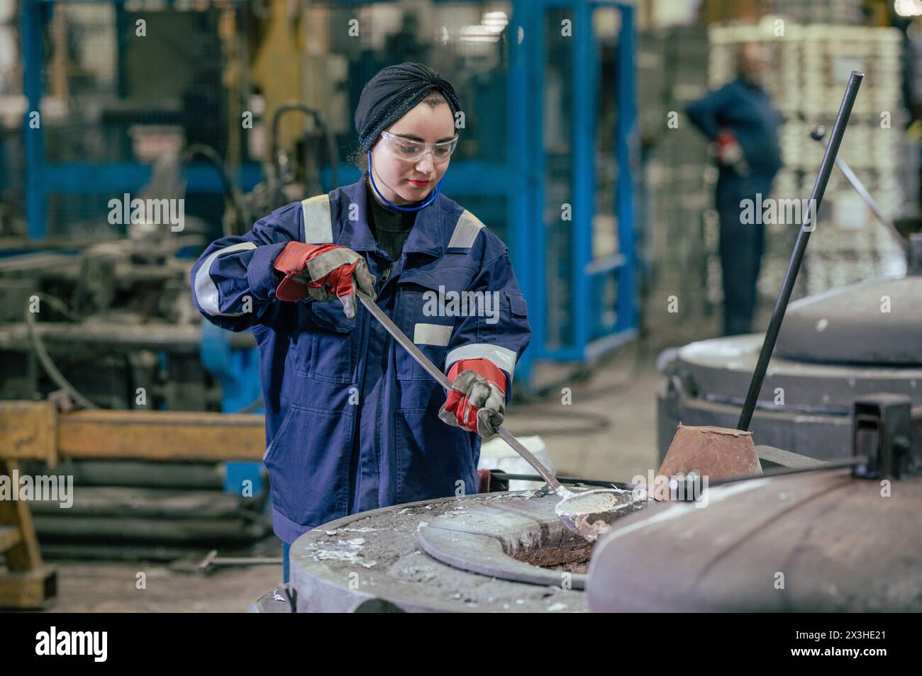 A female worker at a metal specialist. UK Stock Photo