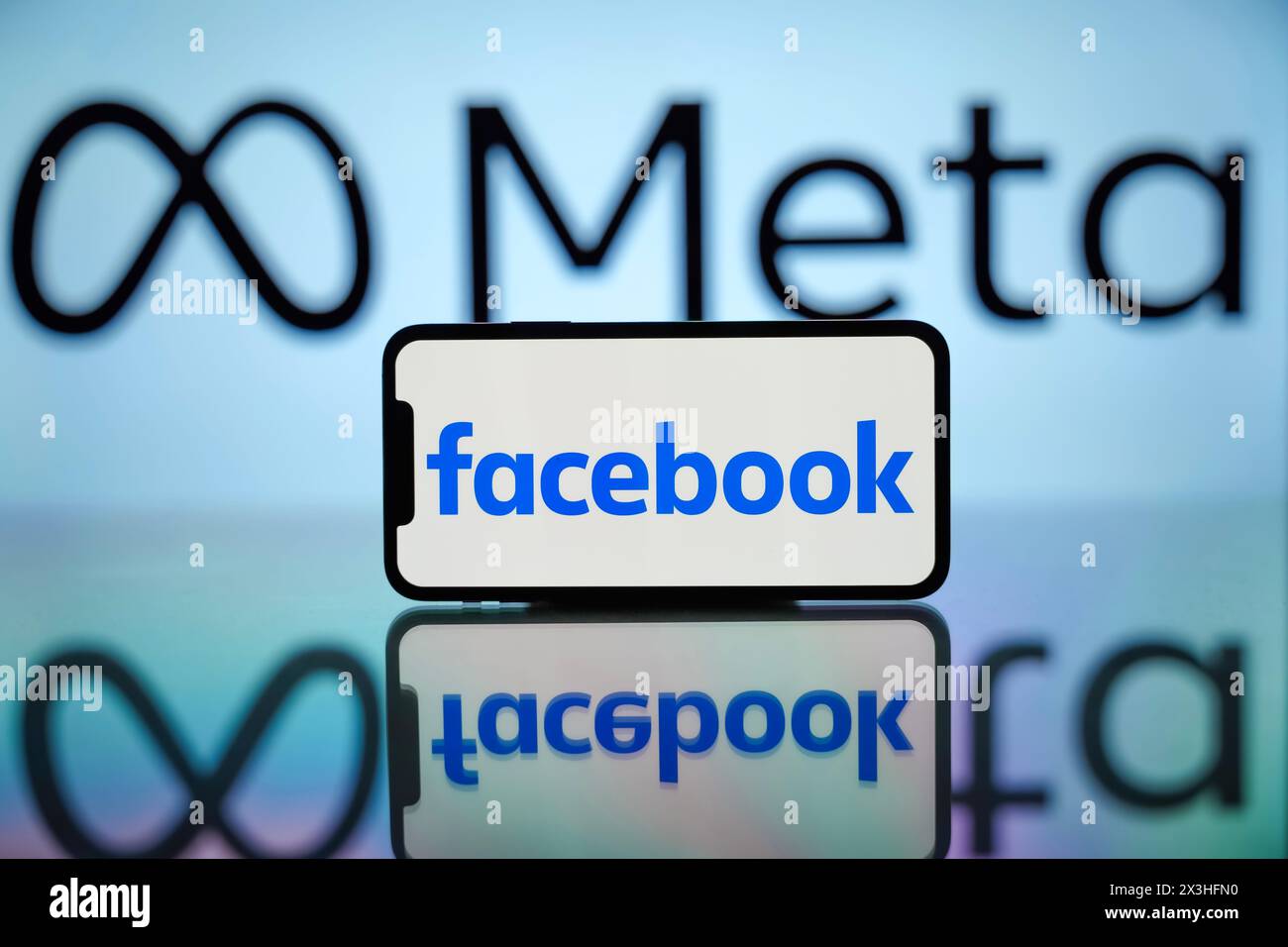 India. 27th Apr, 2024. In this photo illustration, the Facebook logo is seen displayed on a mobile phone screen with Meta logo in the background. Credit: SOPA Images Limited/Alamy Live News Stock Photo