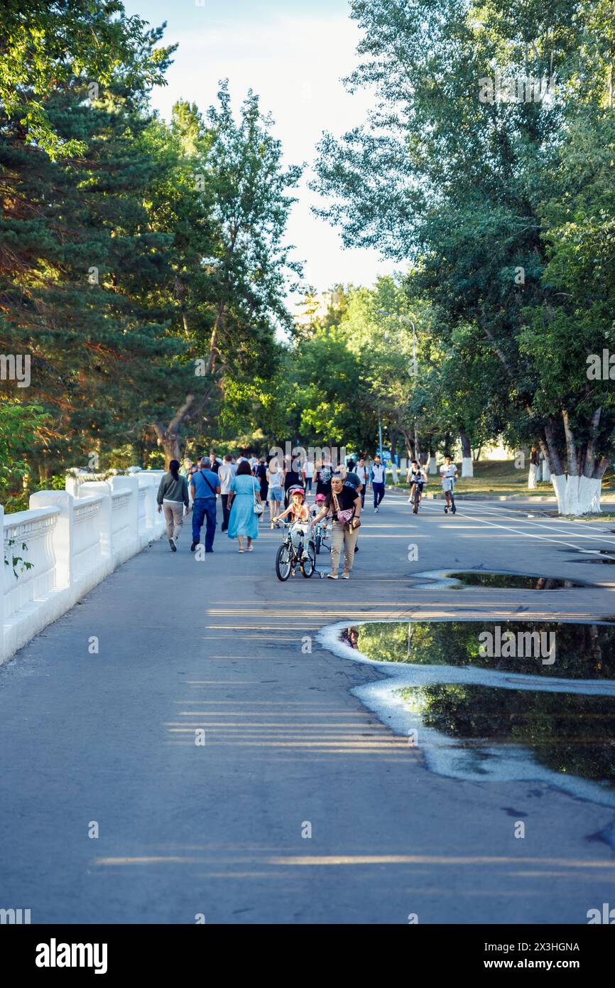 adults and children walk in city park on sunny summer day, weekend. Positive emotions, leisure activity, relax rest. lifestyle. Pavlodar, Kazakhstan 9 Stock Photo