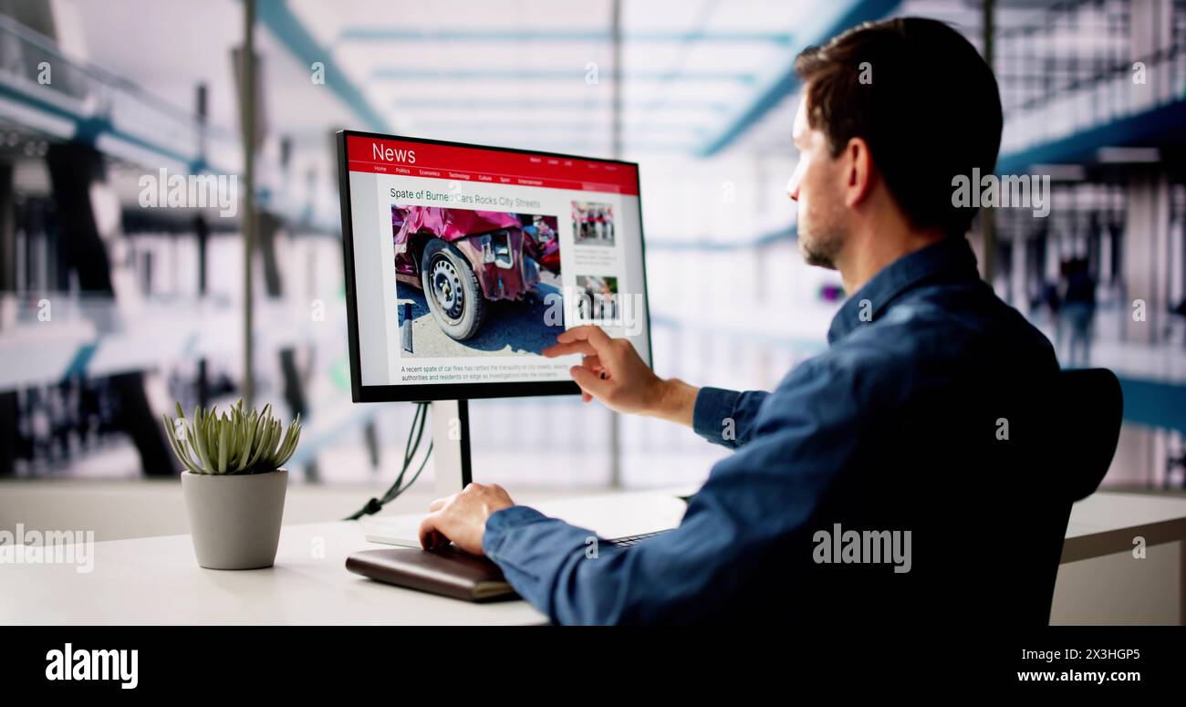 Man Reading News Website On Computer Screen Stock Photo
