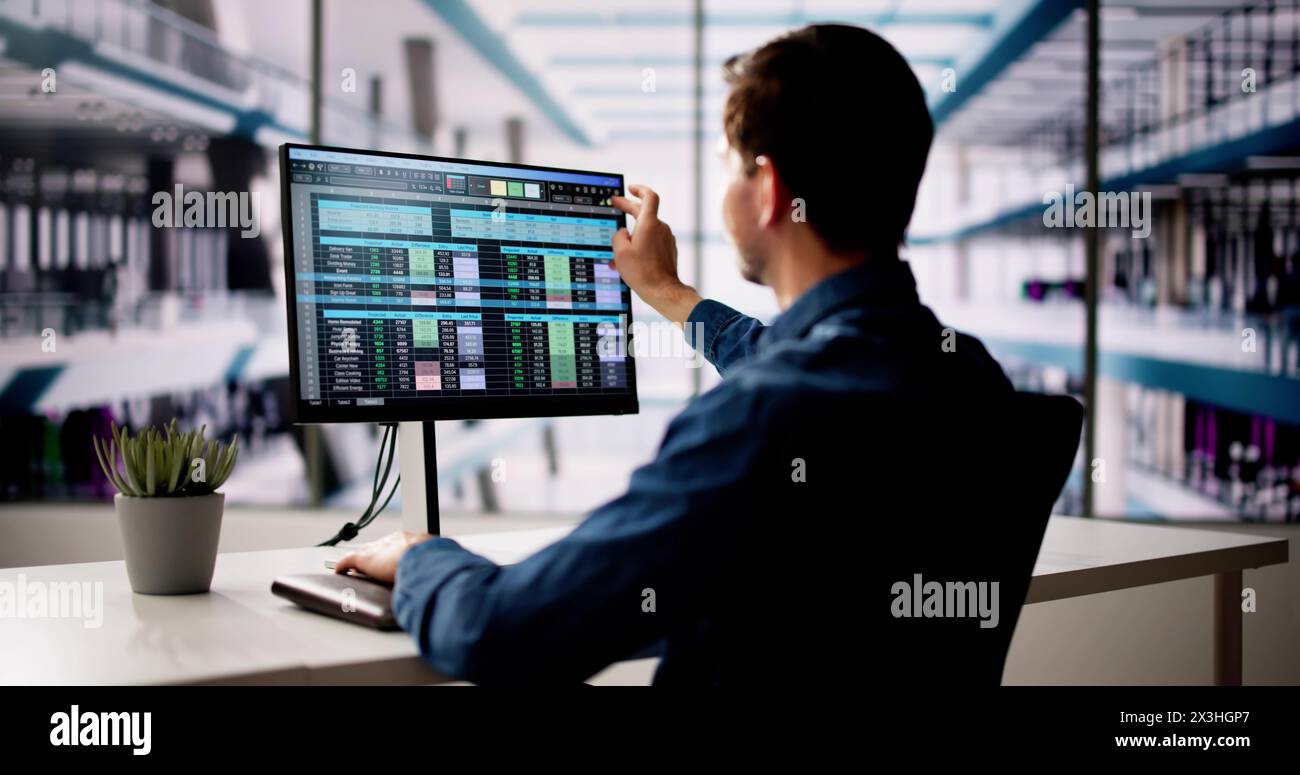 Spreadsheet Analyst Employee Using Computer Monitors For Analysis Stock Photo